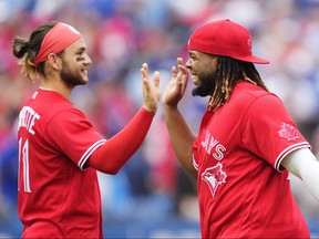 Vladimir Guerrero Jr. and Bo Bichette of the Toronto Blue Jays celebrate defeating the Tampa Bay Rays in their MLB game at the Rogers Centre on July 1, 2022 in Toronto, Ontario, Canada.