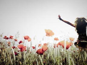 Happy woman in a poppy field