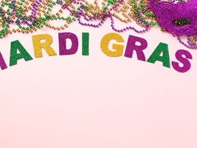 Mardi Gras lettering with colorful beads on color background