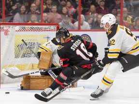 Boston Bruins goalie Jeremy Swayman makes a save on a shot from Ottawa Senators left wing Tim Stutzle in the first period at the Canadian Tire Centre.