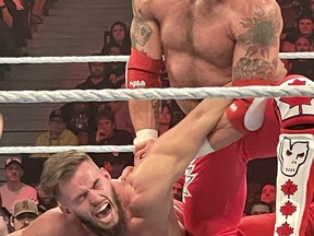 World Wrestling Entertainment Hall of Famer and Canadian Edge performs an armbar on opponent Austin Theory during Monday Night Raw at the Canadian Tire Centre in Ottawa on Monday. Theory retained his United States Championship in the main event thanks to interference from Finn Balor.