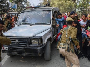 Police personnel take arrested people allegedly involved in child marriages to present before a court in a vehicle as their relatives react, near Mayong police station in Morigaon district of Assam, India, Saturday, Feb. 4, 2023.