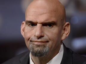 In this file photo taken on Jan. 3, 2023, U.S. Democratic Senator from Pennsylvania John Fetterman looks on as he is ceremonially sworn in by Vice-President Kamala Harris for the 118th Congress in the Old Senate Chamber at the U.S. Capitol in Washington, D.C.