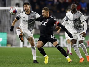 Toronto FC defender Matt Hedges (2) kicks the ball away from D.C. United midfielder Russell Canouse (6) during the first half at Audi Field on Satuday.