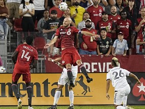 Toronto FC midfielder Michael Bradley (centre) goes up to head the ball against the LA Galaxy during second half MLS action at BMO Field in Toronto, Aug. 31, 2022.