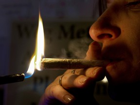 A Dutch woman smokes a cannabis cigarette in a coffee shop in Amsterdam, Oct. 6, 2011.