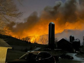 In this photo provided by Melissa Smith, a train fire is seen from her farm in East Palestine, Ohio, Friday, Feb. 3, 2023.