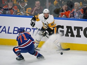 Pittsburgh Penguins captain Sidney Crosby (87) is checked by Edmonton Oilers Ryan McLeod (71) during first period National Hockey League game action in Edmonton on Monday October 24, 2022. The Oilers defeated the Penguins 6-3. (PHOTO BY LARRY WONG/POSTMEDIA)