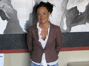 FILE - In this July 24, 2009, file photo, Rachel Dolezal, a leader of the Human Rights Education Institute, stands in front of a mural she painted at the institute's offices in Coeur d'Alene, Idaho. Days after defending its decision to have Dolezal, the white woman who led others to believe she was black, take part in the Baltimore Book Festival, organizers say the former head of the Spokane chapter of the NAACP has been disinvited, Tuesday, May 30, 2017. (AP Photo/Nicholas K. Geranios, File)