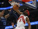 Memphis, Tennessee, USA; Toronto Raptors forward Precious Achiuwa (5) dunks over Memphis Grizzlies forward Jaren Jackson Jr. (13) during the first half at FedExForum. 