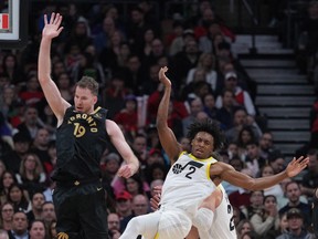 Toronto Raptors centre Jakob Poeltl (19) battles for the ball with Utah Jazz guard Collin Sexton (2) during the second quarter at Scotiabank Arena.