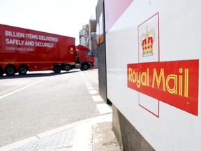 The logo of Britain's Royal Mail is seen outside the Mount Pleasant Sorting Office as a delivery vehicle arrives, in London, June 25, 2020.