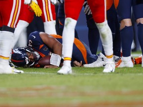 Russell Wilsonof the Denver Broncos lies on the field after sustaining a concussion in the fourth quarter of a game against the Kansas City Chiefs at Empower Field At Mile High on December 11, 2022.