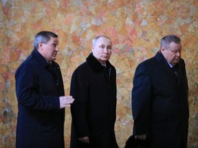 Russian President Vladimir Putin walks with Governor of the Volgograd region Andrei Bocharov (left) and Plenipotentiary Envoy in the Southern Federal District Vladimir Ustinov after a wreath-laying ceremony during an event marking the 80th anniversary of the Battle of Stalingrad in the Second World War, at the Mamayev Kurgan memorial complex in Volgograd, Russia, Feb. 2, 2023.