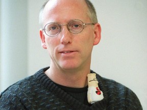 "Dilbert" cartoonist Scott Adams poses for a photo in Toronto during a promotional tour, Nov. 13, 2002.