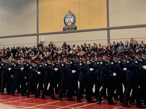 The Toronto Police College graduating class of 2023 march past their family and friends at a ceremony held at TPC on Thursday, Feb. 16, 2023.