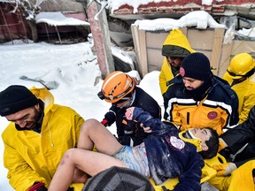 Rescuers and medics carry 8-year-old boy Arda Gul from the debris of a collapsed building following an earthquake in Elbistan, Kahramanmaras province, Turkey February 7, 2023.