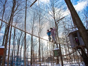 Woman and boy high above the ground in Treetop Village.