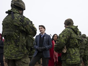 Canadian Prime Minister Justin Trudeau and Minister of Defence Anita Anand speak with Canadian troops deployed on Operation Reassurance as he visits the Adazi Military base in Adazi, Latvia,  Tuesday, March 8, 2022.  THE CANADIAN PRESS/Adrian Wyld