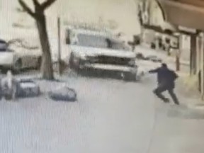 A screenshot from surveillance footage posted to Twitter captures a man driving a U-Haul truck struck that injured several pedestrians in New York City on Monday before police were able to pin the careening vehicle against a building following a miles long pursuit through Brooklyn.