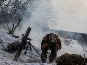 A Ukrainian service member fires a mortar towards Russian troops near the Vuhledar town, amid Russia's attack on Ukraine, in Donetsk region, Ukraine February 7, 2023.