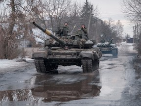 Ukrainian service members ride tanks, as Russia's attack on Ukraine continues, near the frontline town of Bakhmut, Donetsk region, Ukraine, Feb. 21, 2023.