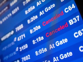 A screen showing cancelled flights is seen at John F. Kennedy International Airport in Queens, New York City, Dec. 26, 2021.