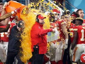 Kansas City Chiefs head coach Andy Reid is dunked with Gatorade by his players Jordan Lucas (24) and Cameron Erving (75) in the fourth quarter against the San Francisco 49ers in Super Bowl LIV at Hard Rock Stadium.