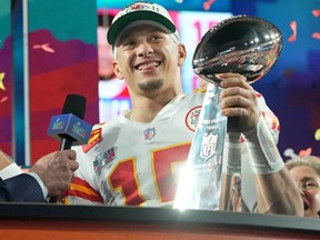 Kansas City Chiefs quarterback Patrick Mahomes (15) holds the Vince Lombardi Trophy after winning Super Bowl LVII against the Philadelphia Eagles.