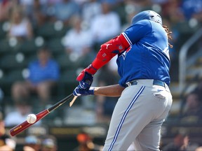 Toronto Blue Jays first baseman Vladimir Guerrero Jr. (27) breaks his bat against the Pittsburgh Pirates in the first inning during spring training at LECOM Park.