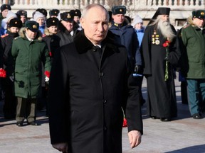 Russian President Vladimir Putin attends a wreath laying ceremony at the Tomb of the Unknown Soldier by the Kremlin Wall on the Defender of the Fatherland Day in Moscow, Thursday, Feb. 23, 2023.