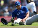 Blue Jays pitcher Yusei Kikuchi dives for a ball against the Pirates in the first inning against the Pirates in Bradenton Saturday.