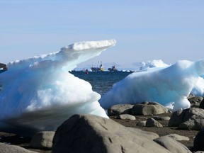 Ships are framed by pieces of melting sea ice in Frobisher Bay in Iqaluit, Nunavut on Wednesday, July 31, 2019.