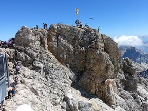 A golden cross marks the top of the Zugspitze — the highest point in Germany.
