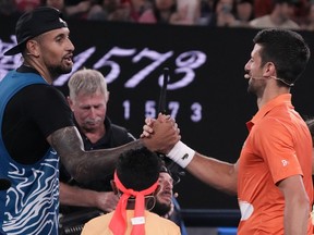 Australia's Nick Kyrgios, left, and Serbia's Novak Djokovic shake hands following an exhibition match on Rod Laver Arena in Melbourne, Australia, Friday, Jan. 13, 2023.