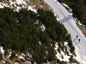 People climb near the 2,334 m (7,657 ft) Hafelekarsummit at the "Nordkette" Alps mountains in Innsbruck, Austria, on Jan. 2, 2023.