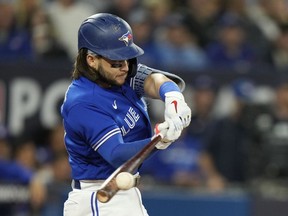 Blue Jays shortstop Bo Bichette hits a double during the American League wild card game against the Seattle Mariners in Toronto on Saturday, Oct. 8, 2022.
