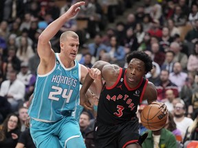 Toronto Raptors forward O.G. Anunoby (3) dribbles the ball as Charlotte Hornets centre Mason Plumlee (24) defends during first half NBA basketball action in Toronto on Thursday, Jan. 12, 2023.
