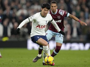 Tottenham's Son Heung-min in action against West Ham's Thilo Kehrer during the English Premier League soccer match between Tottenham Hotspur and West Ham United at Tottenham Hotspur stadium in London, Sunday, Feb. 19, 2023.