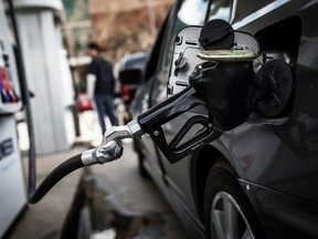 A fuel pump is seen in a car at a gas station in Toronto April 22, 2014.