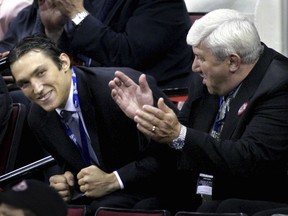Alex Ovechkin, left, of Russia, reacts after being selected as the first overall pick by the Washington Capitals during the NHL Draft, June 26, 2004, at the RBC Center in Raleigh, N.C. At right is Ovechkin's father Mikhail.