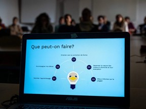 Teachers are seen behind a laptop during a workshop on ChatGPT bot organized for by the School Media Service (SEM) of the Public education of the Swiss canton of Geneva, on Feb. 1, 2023.