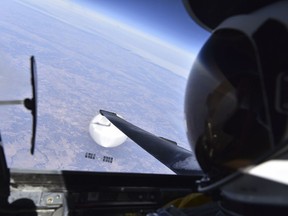 In this image released by the Department of Defense on Wednesday, Feb. 22, 2023, a U.S. Air Force U-2 pilot looks down at a suspected Chinese surveillance balloon as it hovers over the United States on Feb. 3, 2023.