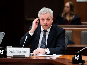 Director of the Canadian Security Intelligence Service (CSIS), David Vigneault, adjusts a translation aid as he waits to appear before a Special Committee on Parliament Hill in Ottawa, on Monday, Feb. 6, 2023.