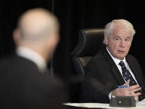 Public Order Emergency Commission's Commissioner Paul Rouleau speaks to counsel during a witnesses' testimony, Monday, Oct. 31, 2022, in Ottawa. A federal commission is set to report today on the Liberal government's use of the Emergencies Act against protests that paralyzed the streets around Parliament Hill and jammed several Canadian border points early last year.