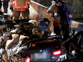 The remnants of a BMW are seen after a violent single-vehicle crash on the Hwy. 427 southbound exit ramp to Dundas on Monday, Feb. 13, 2023.