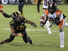 Hamilton Tiger Cats wide receiver Tim White and BC Lions linebacker Williams dive for a loose ball during second half CFL football game action in Hamilton, Ont. on Friday, November 5, 2021.