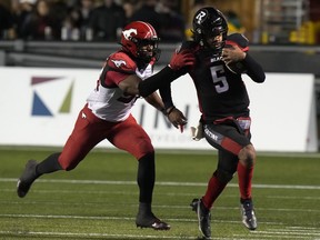 Calgary Stampeders linebacker Jameer Thurman chases Ottawa Redblacks quarterback Caleb Evans during second half CFL action, Friday, October 29, 2021 in Ottawa. Thurman is on the move. A CFL source said Wednesday the veteran linebacker has agreed to terms on a contract with the Hamilton Tiger-Cats.