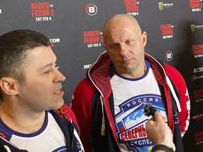 Fedor Emelianenko, rights, listens to interpreter Georgiy Litvinov during an interview in Los Angeles on Wednesday, Feb. 1, 2023.