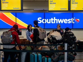 A family speaks with Southwest associates at the Austin-Bergstrom International Airport on Jan. 31, 2023 in Austin, Texas.